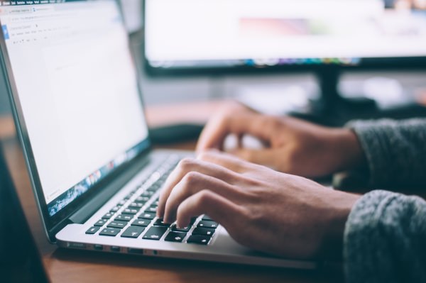 Person logging into patient portal on laptop